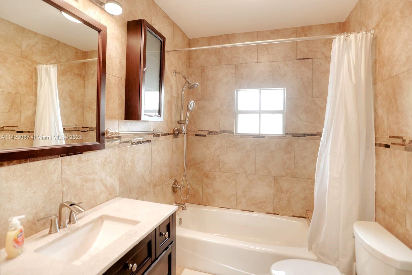 3628 Thomas Avenue Miami, FL 33133 - Photo 20 of 24 a bathroom with a sink and a mirror