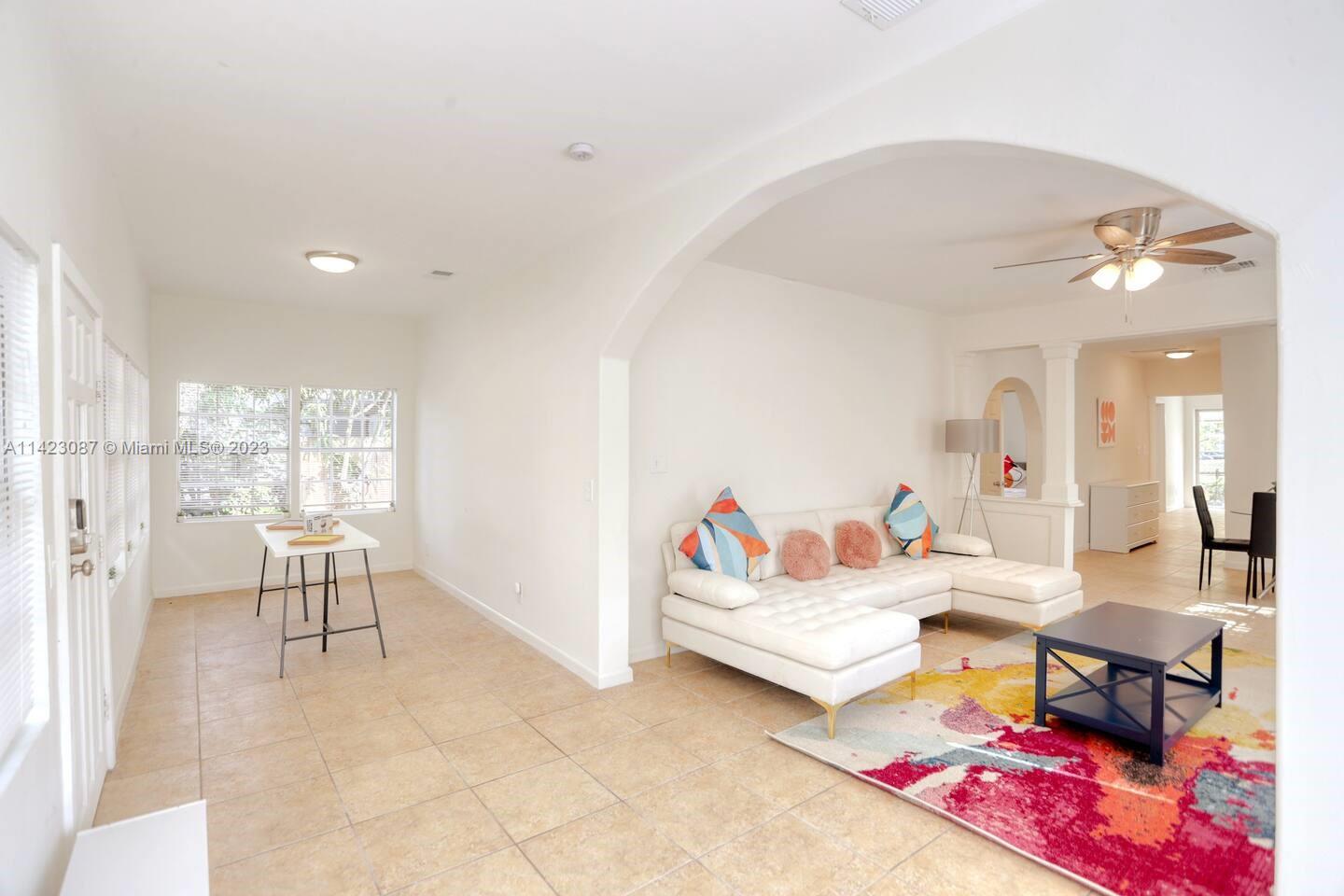3628 Thomas Avenue Miami, FL 33133 - Photo 2 of 24 a living room with furniture and a rug
