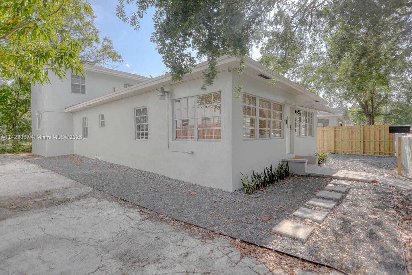 3628 Thomas Avenue Miami, FL 33133 - Photo 23 of 24 a view of a house with a yard