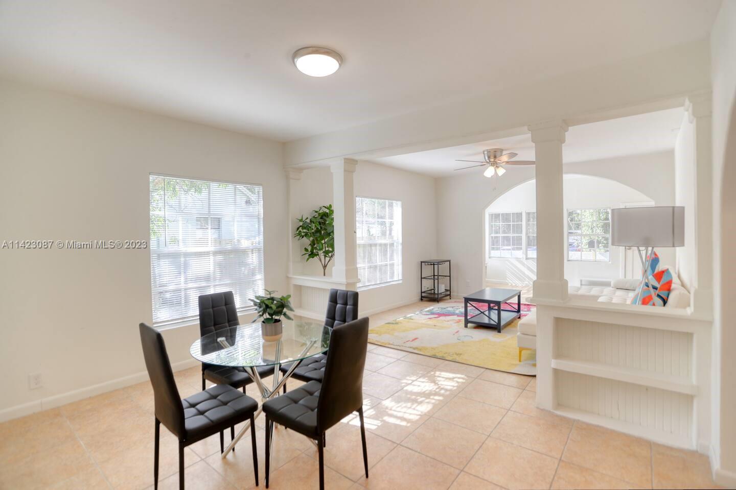 3628 Thomas Avenue Miami, FL 33133 - Photo 3 of 24 a living room with furniture and a large window