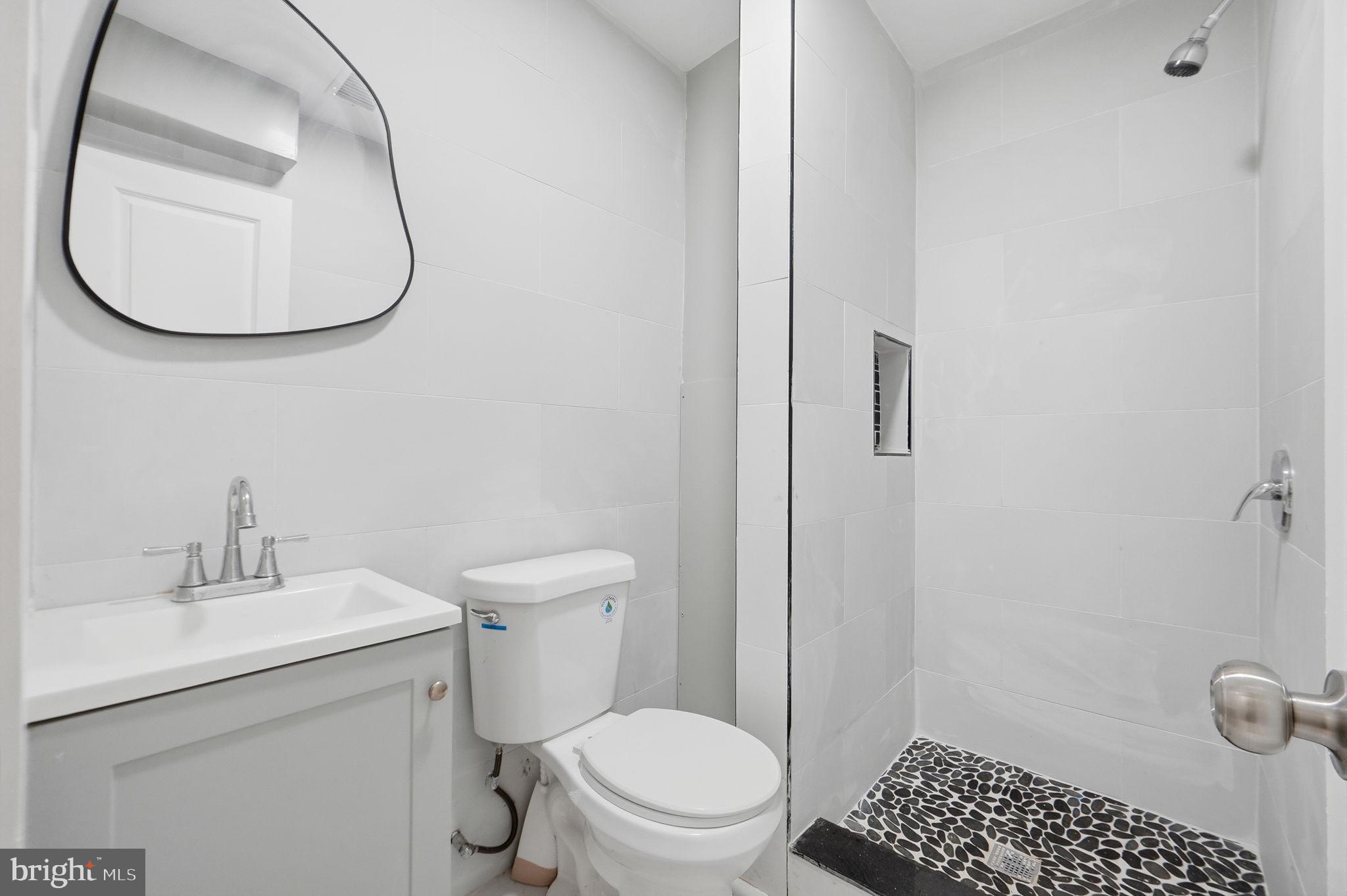 5906 Berwyn Road College Park, MD 20740 - Photo 29 of 46 a bathroom with a sink a toilet and a mirror