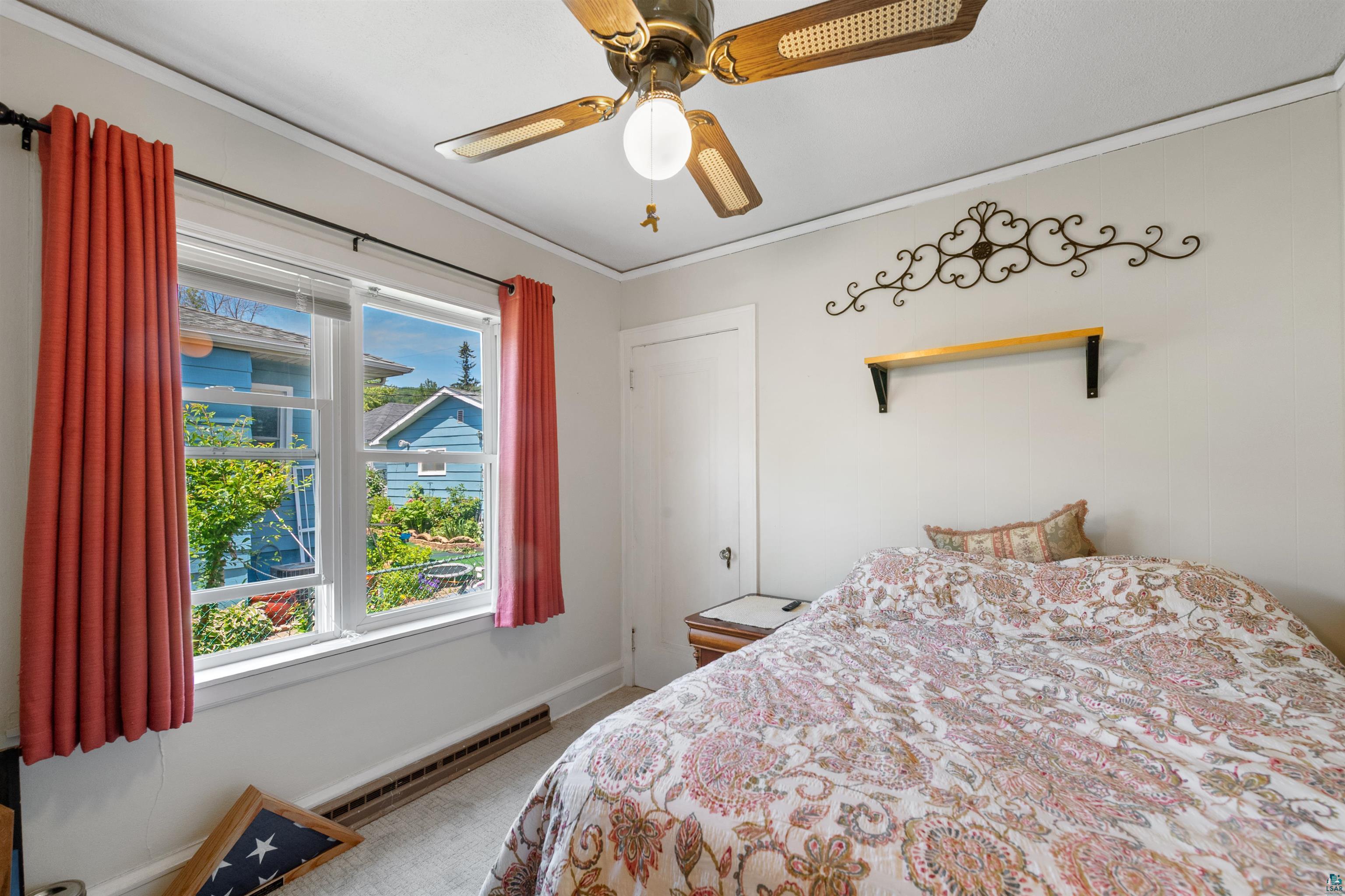 3209 Chestnut Street Duluth, MN 55806 - Photo 11 of 28 Room featuring a ceiling fan with integrated lighting, two double-hung windows, a wall-mounted shelf, and baseboard trim