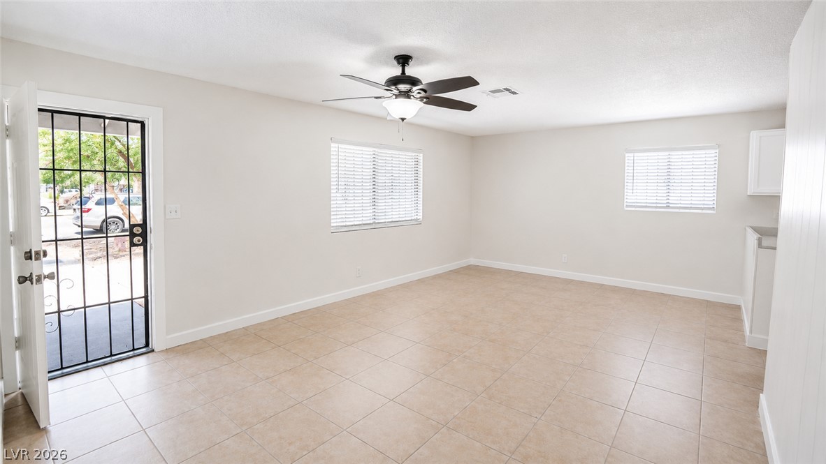 2870 South Sandhill Road Las Vegas, NV 89121 - Photo 42 of 64 A spacious, naturally illuminated room featuring durable tiled flooring and a convenient ceiling fan.
