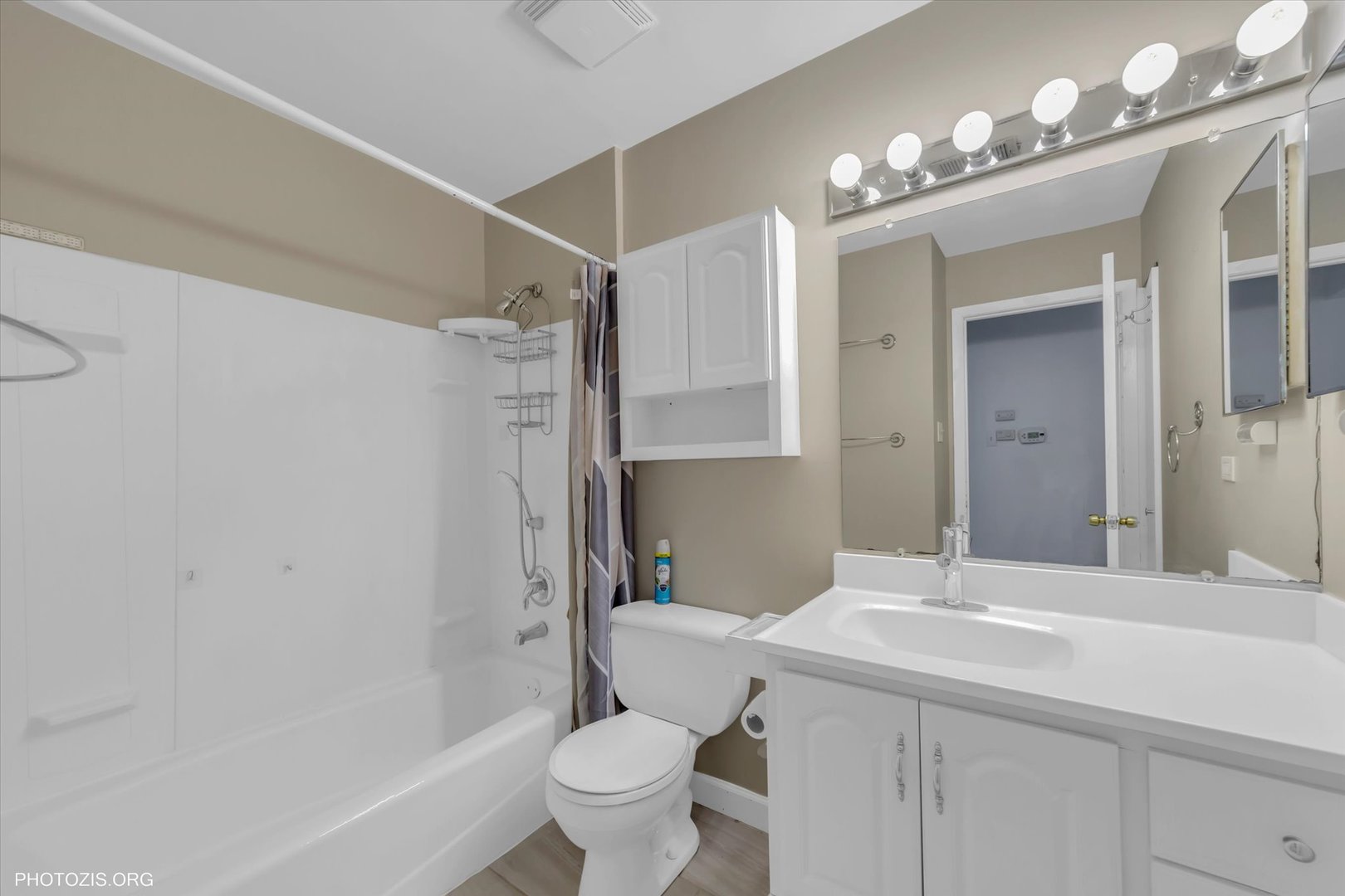 918 East Kings Row, Unit 1 Palatine, IL 60074 - Photo 11 of 23 a bathroom with a sink a toilet a mirror a vanity and shower