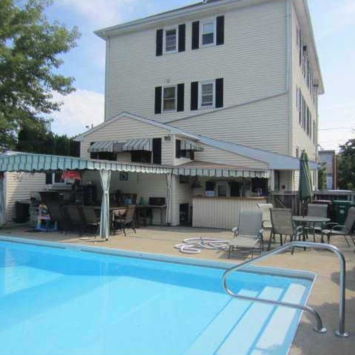 52 3rd Avenue Woonsocket, RI 02895 - Photo 2 of 27 Back yard view with pool and patio area