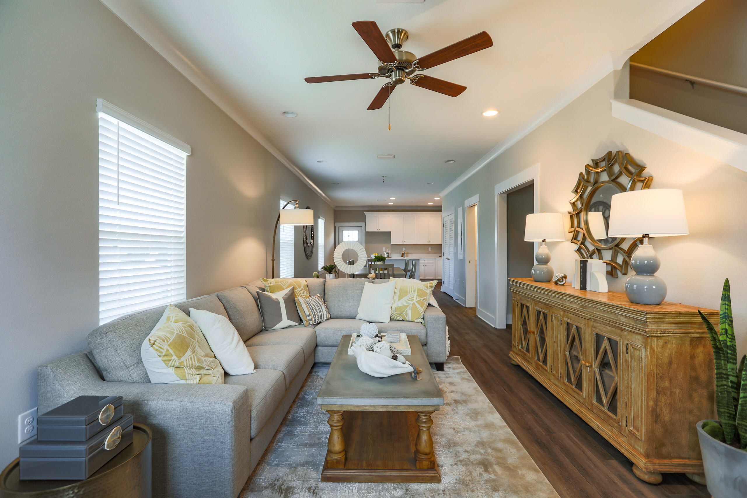 a living room with furniture and a wooden floor