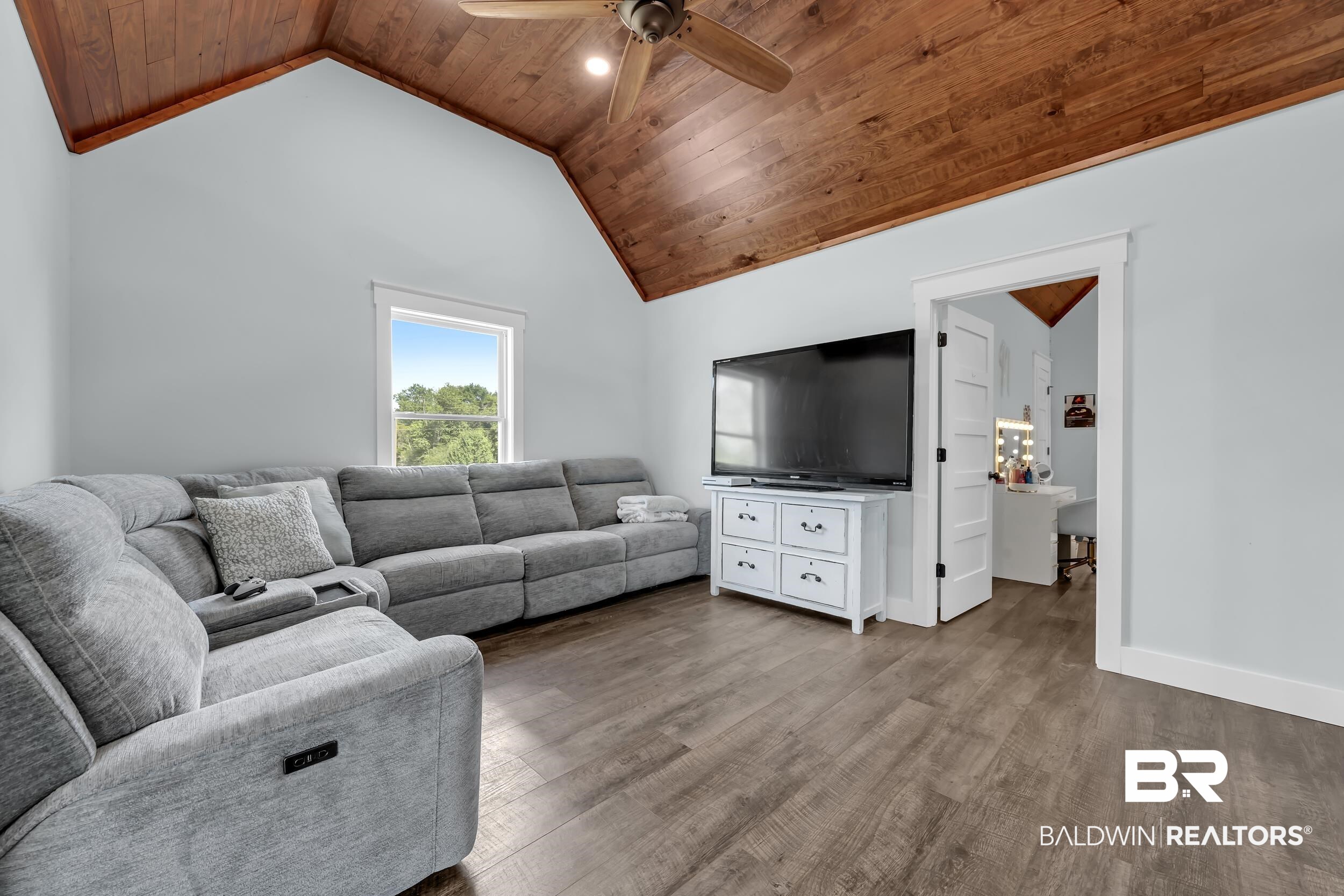 6576 Ranch Loop Road East Grand Bay, AL 36541 - Photo 24 of 39 Spacious room featuring a vaulted wood-finish ceiling with a ceiling fan, light-toned walls, and wood-finish flooring