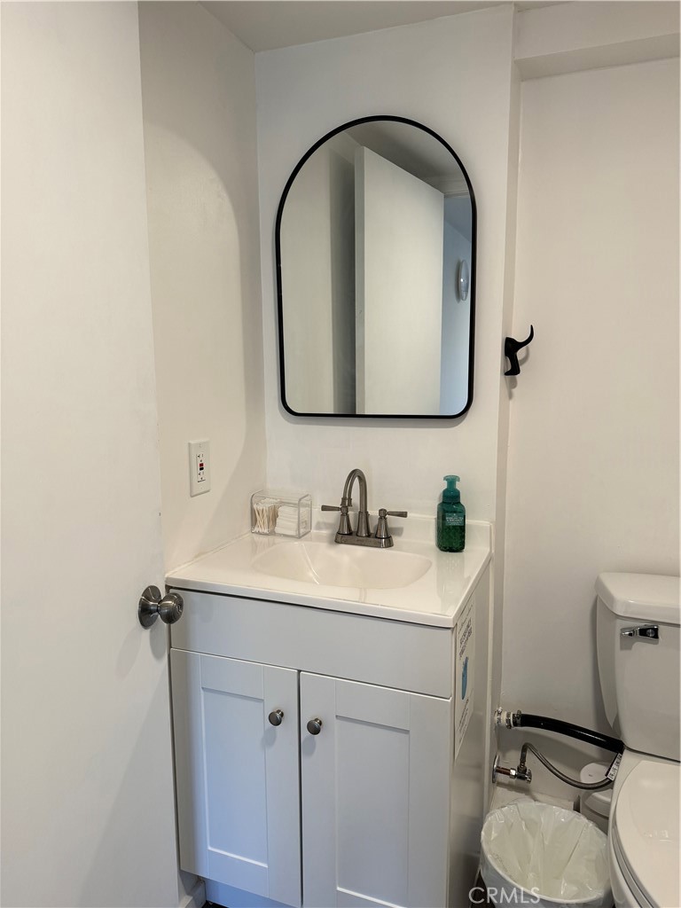 774 Stephens Avenue Fullerton, CA 92833 - Photo 6 of 9 a bathroom with a toilet sink vanity and mirror