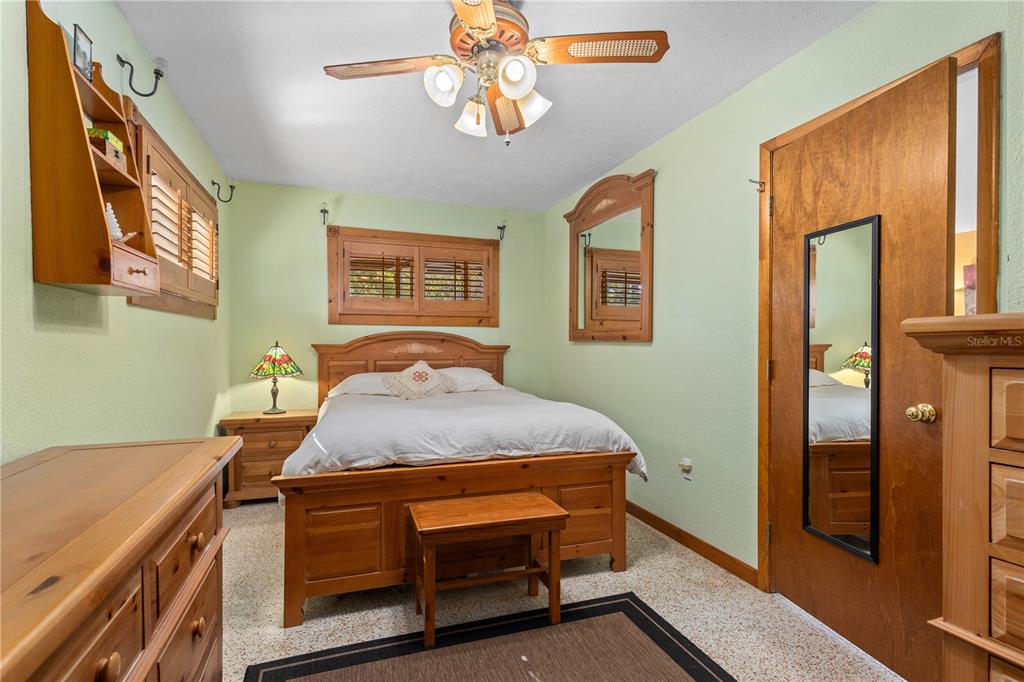 109 Burney Road Osprey, FL 34229 - Photo 18 of 56 Primary bedroom with wood shutters