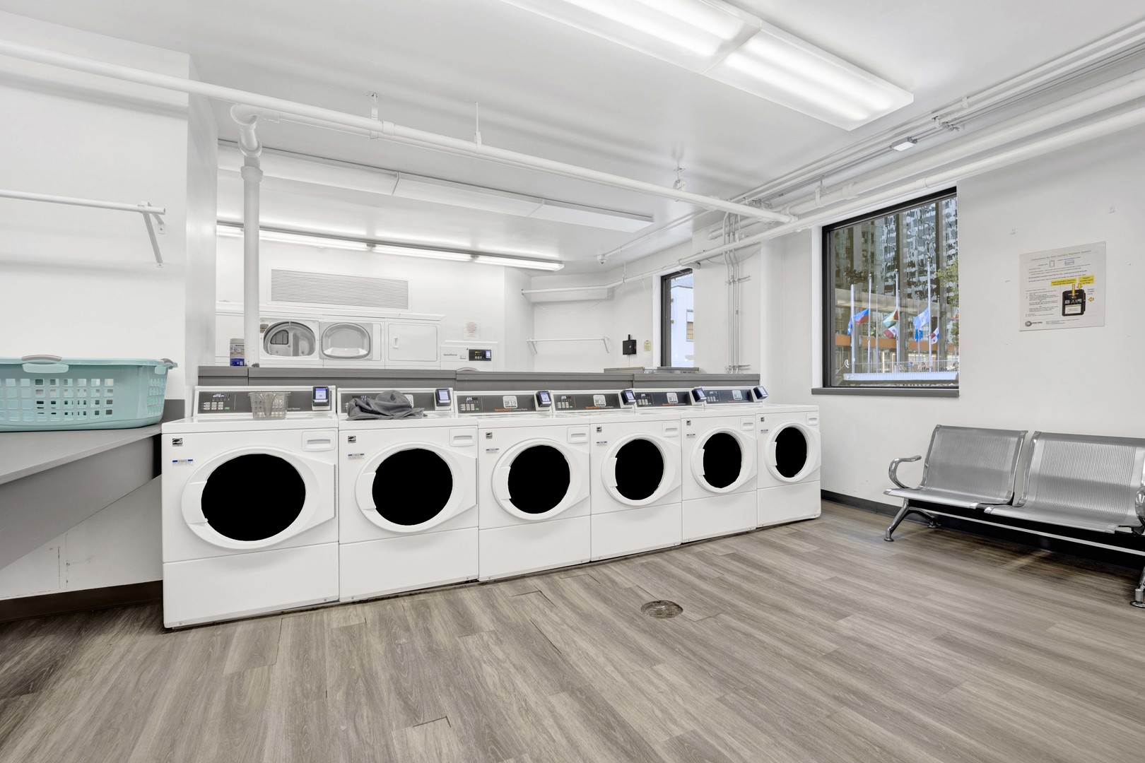 405 North Wabash Avenue, Unit 2614 Chicago, IL 60611 - Photo 19 of 22 a utility room with stainless steel appliances wooden floors and white walls