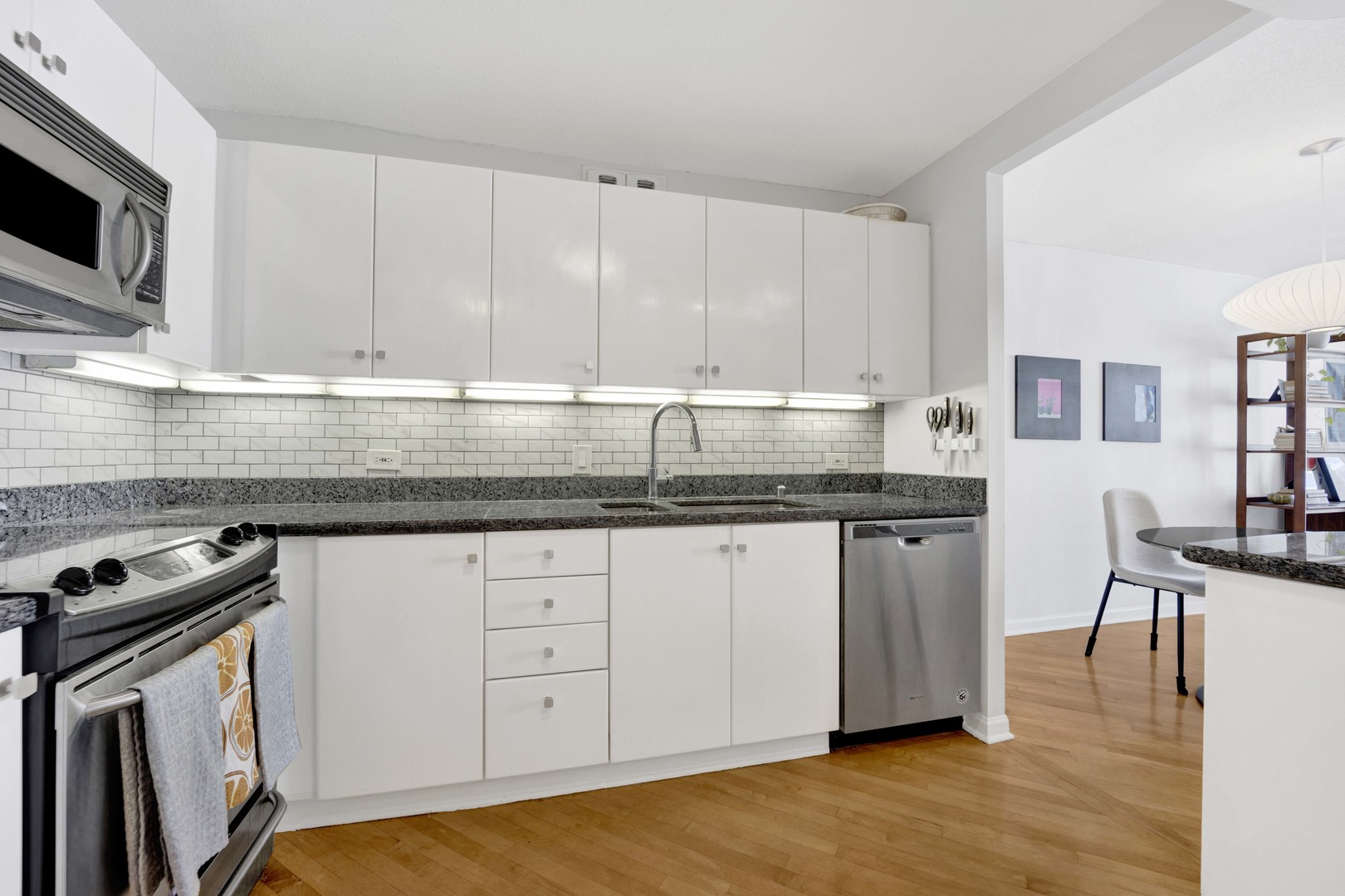 405 North Wabash Avenue, Unit 2614 Chicago, IL 60611 - Photo 3 of 22 a kitchen with granite countertop a sink a stove and cabinets