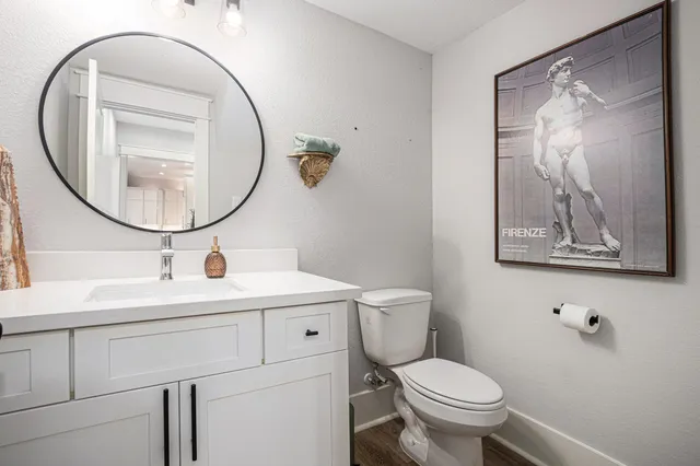 a bathroom with a toilet sink and mirror