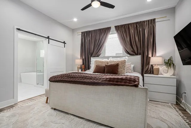 a bedroom with a bed and a flat screen tv