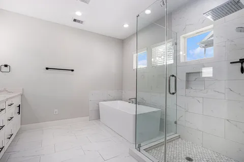 a bathroom with a bathtub and shower