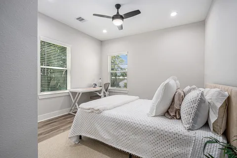 a bedroom with a bed and a window