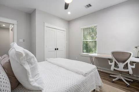 a bedroom with a bed and chair