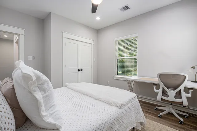 a bedroom with a bed and chair