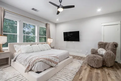 a bedroom with a bed and a flat screen tv