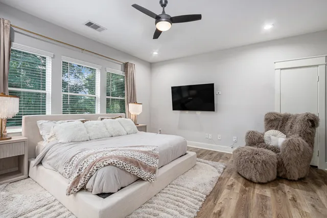 a bedroom with a bed and a flat screen tv