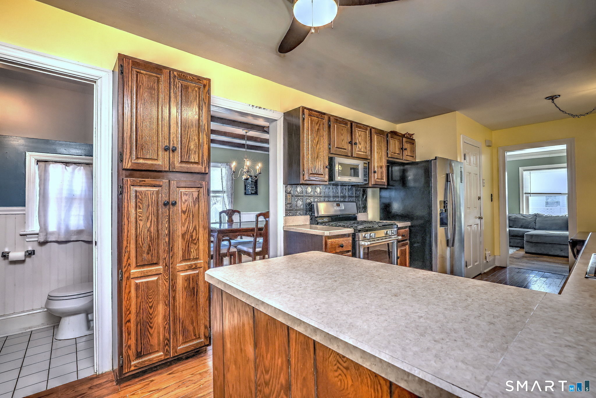 51 Joy Road Waterbury, CT 06708 - Photo 20 of 39 a kitchen with stainless steel appliances kitchen island granite countertop a refrigerator a stove and a sink with wooden floor
