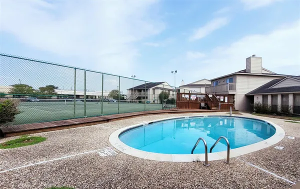 a view of a swimming pool with a patio