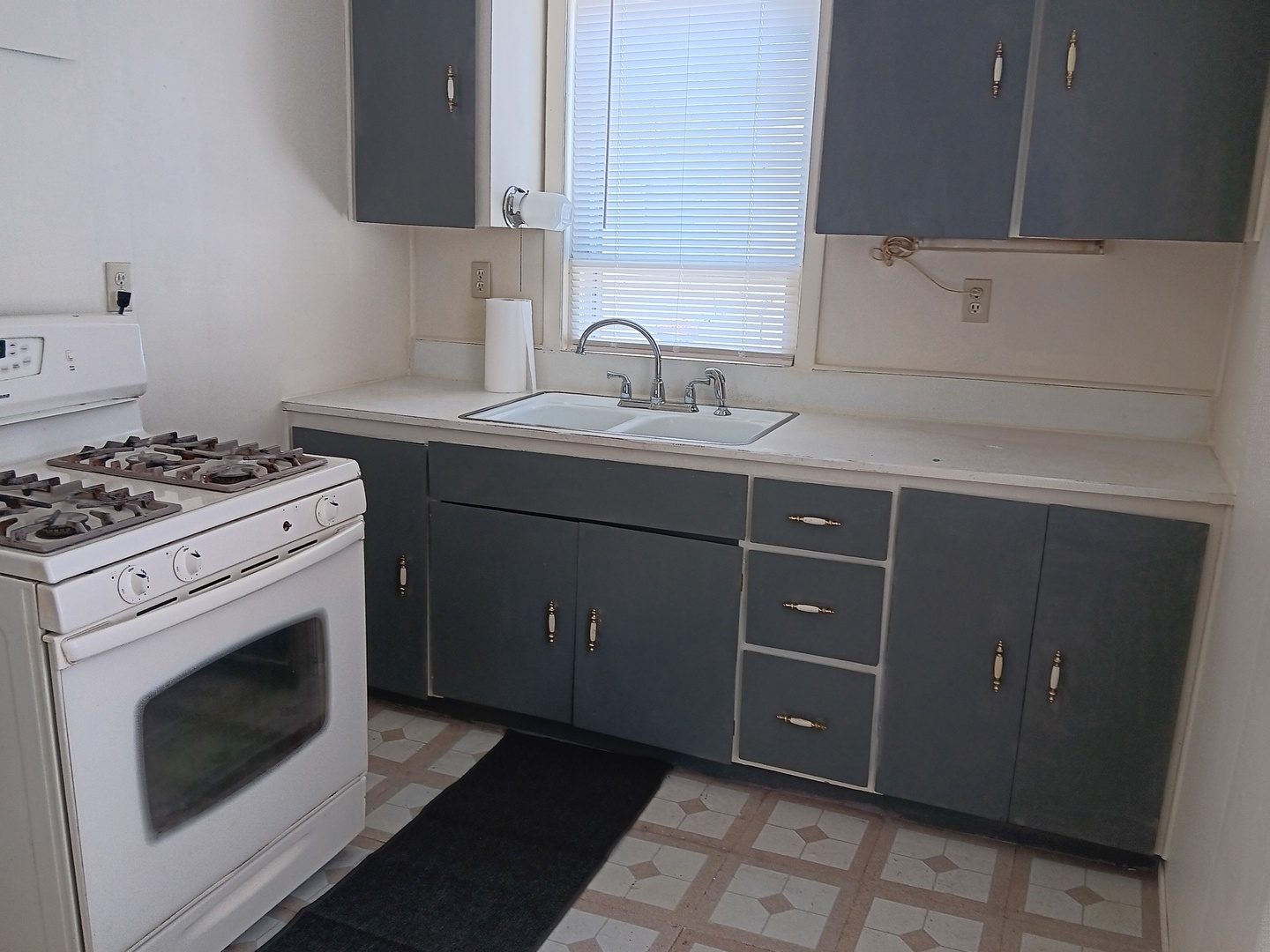1517 Pine Street Ottawa, IL 61350 - Photo 2 of 4 a kitchen with a stove sink and cabinets