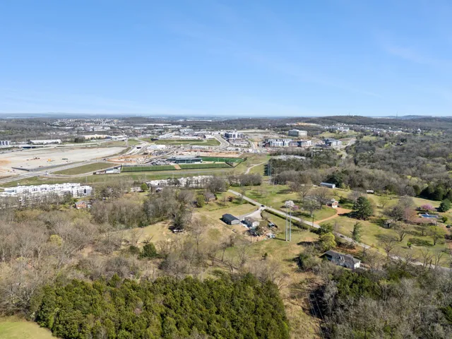 an aerial view of residential building and lake