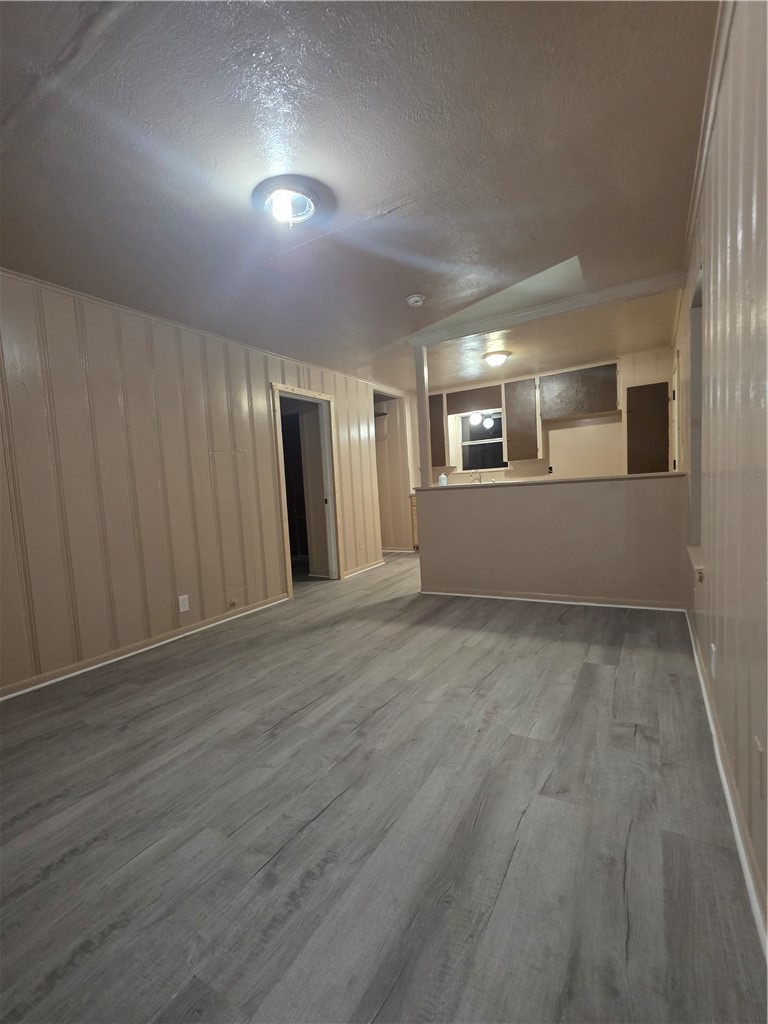408 North Live Oak Street Mathis, TX 78368 - Photo 2 of 7 an empty room with wooden floor and windows