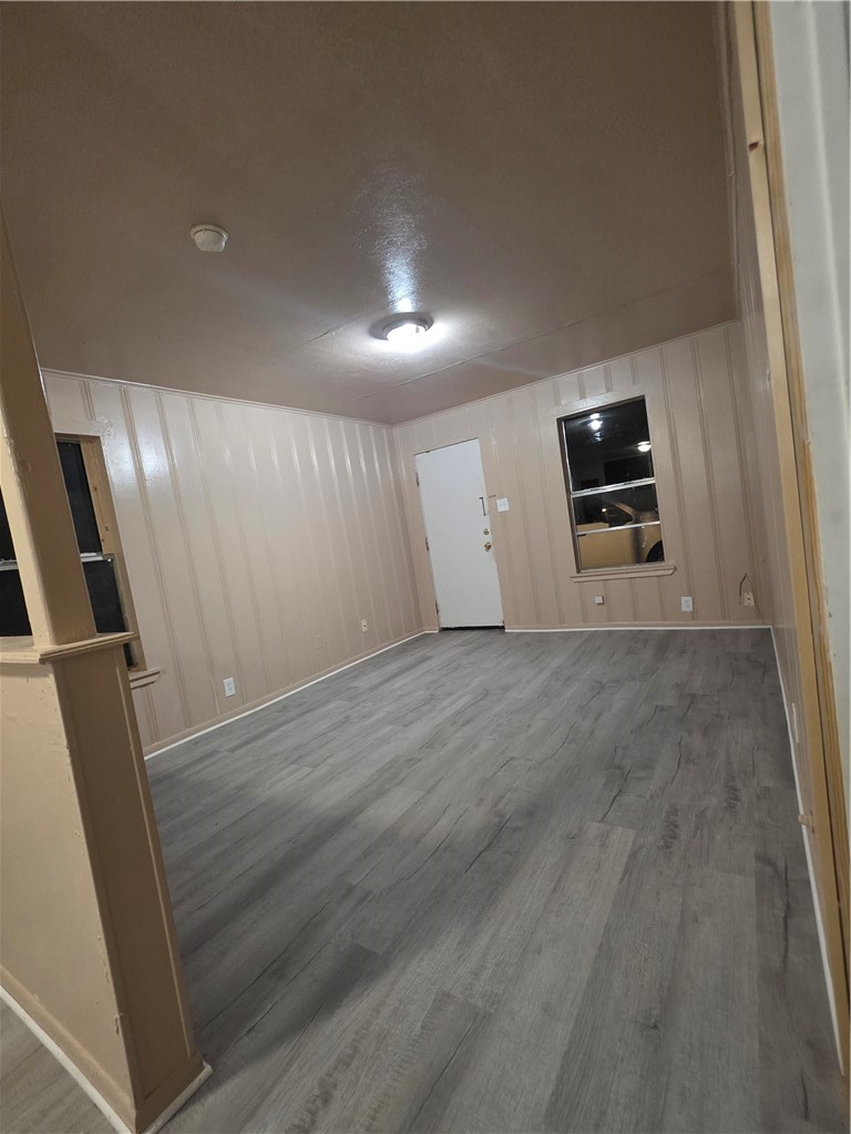 408 North Live Oak Street Mathis, TX 78368 - Photo 4 of 7 an empty room with wooden floor and windows