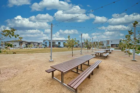 a swimming pool with outdoor seating and barbeque area