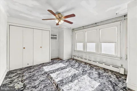 a view of a livingroom with a ceiling fan and window