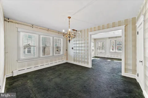 an empty room with windows and entrance