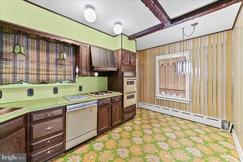 a kitchen with a sink a stove and cabinets