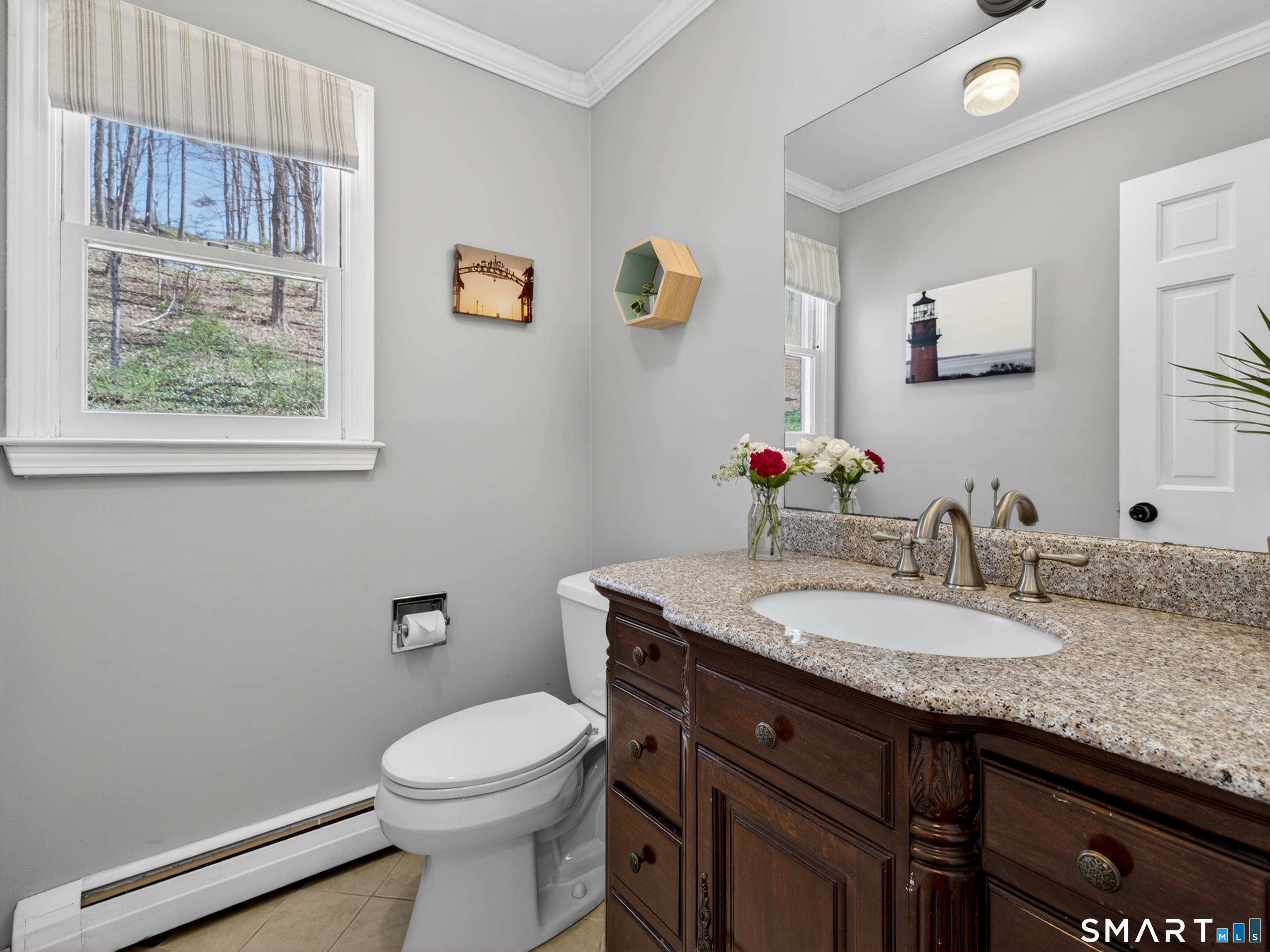 599 Durham Road Guilford, CT 06437 - Photo 18 of 42 a bathroom with a granite countertop toilet sink and mirror