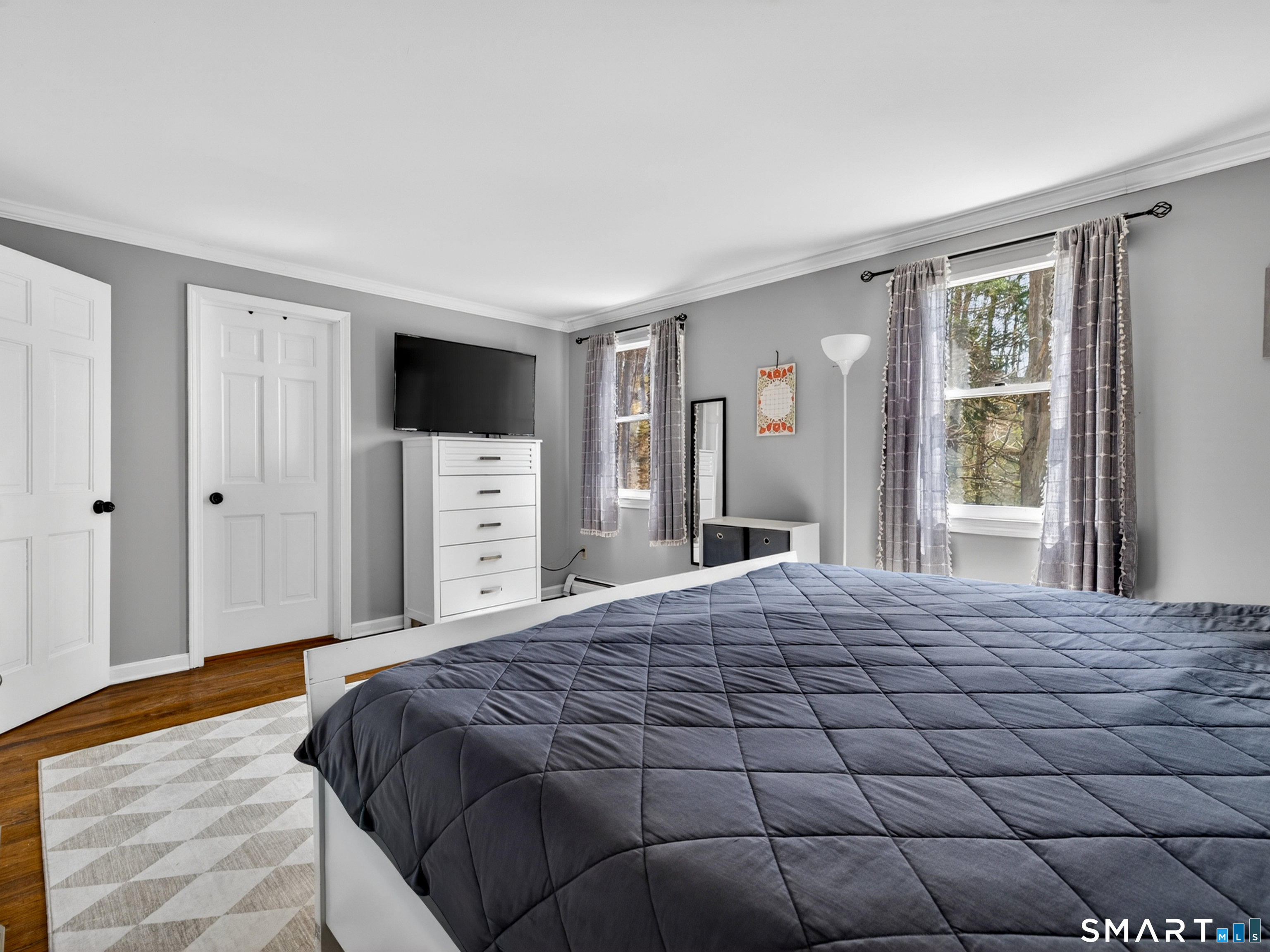599 Durham Road Guilford, CT 06437 - Photo 26 of 42 a bedroom with a large bed and a flat screen tv