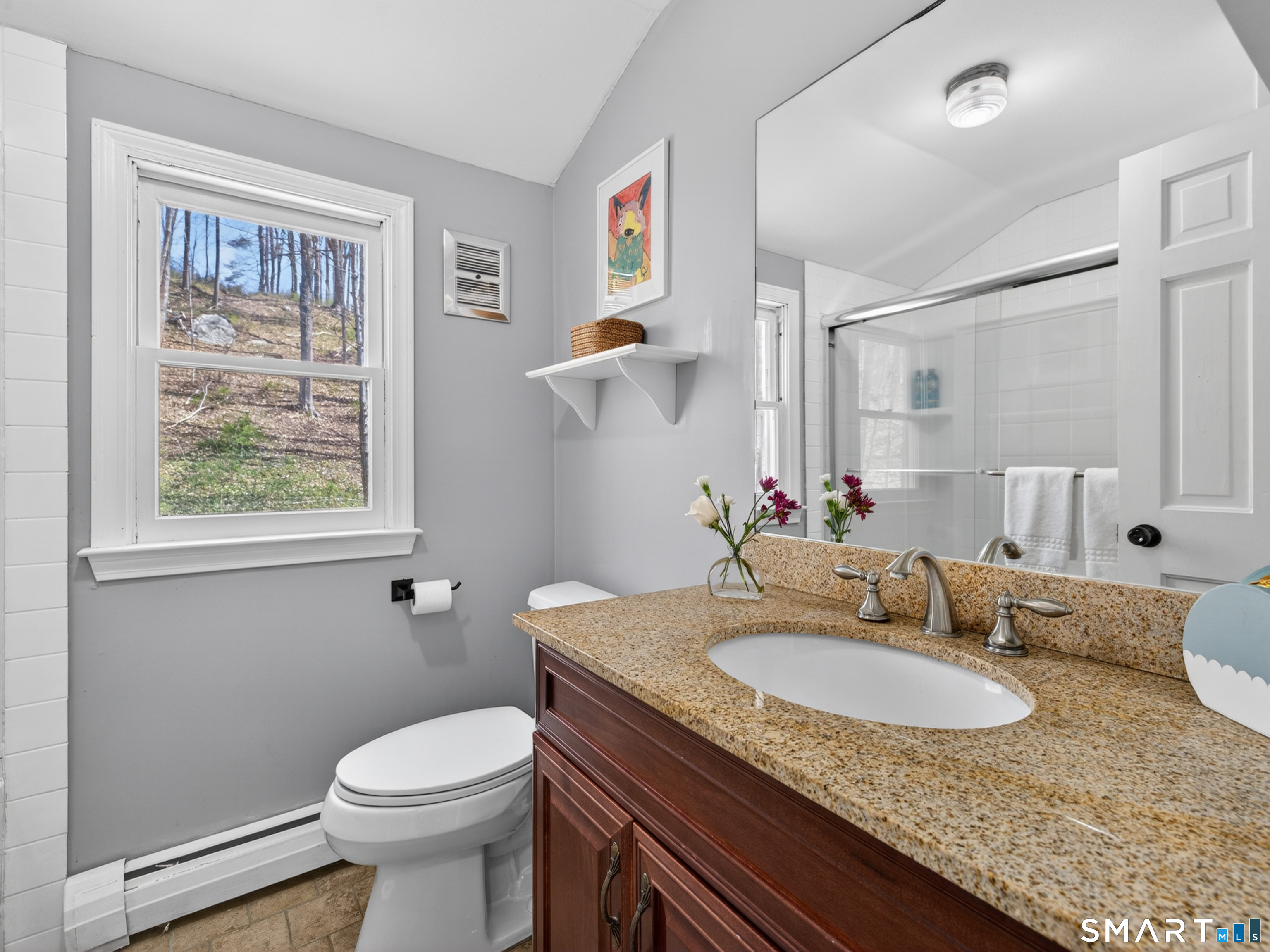 599 Durham Road Guilford, CT 06437 - Photo 27 of 42 a bathroom with a granite countertop sink a toilet and a mirror