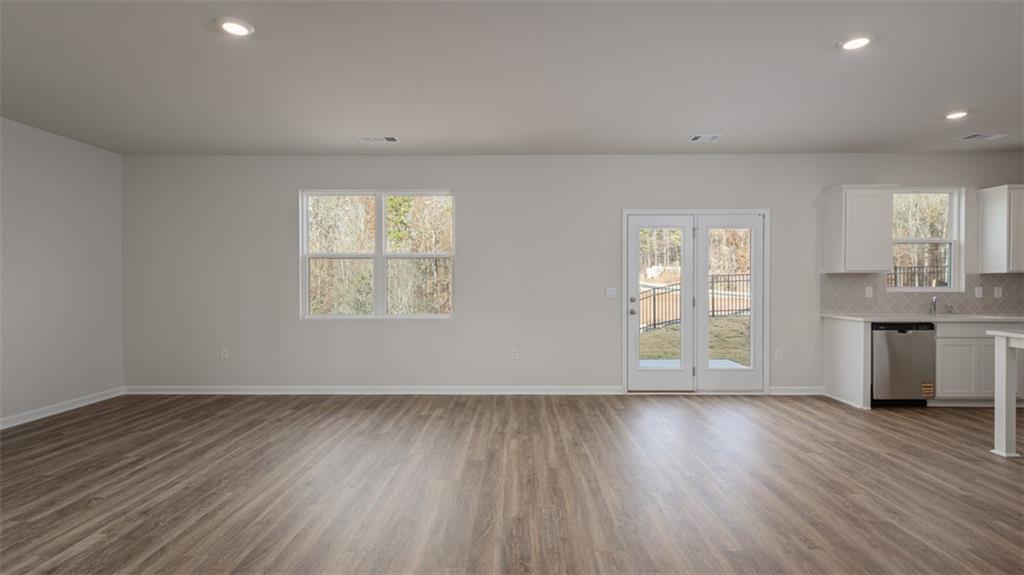 2291 Edgecombe Lane Dacula, GA 30019 - Photo 14 of 42 an empty room with wooden floor and windows