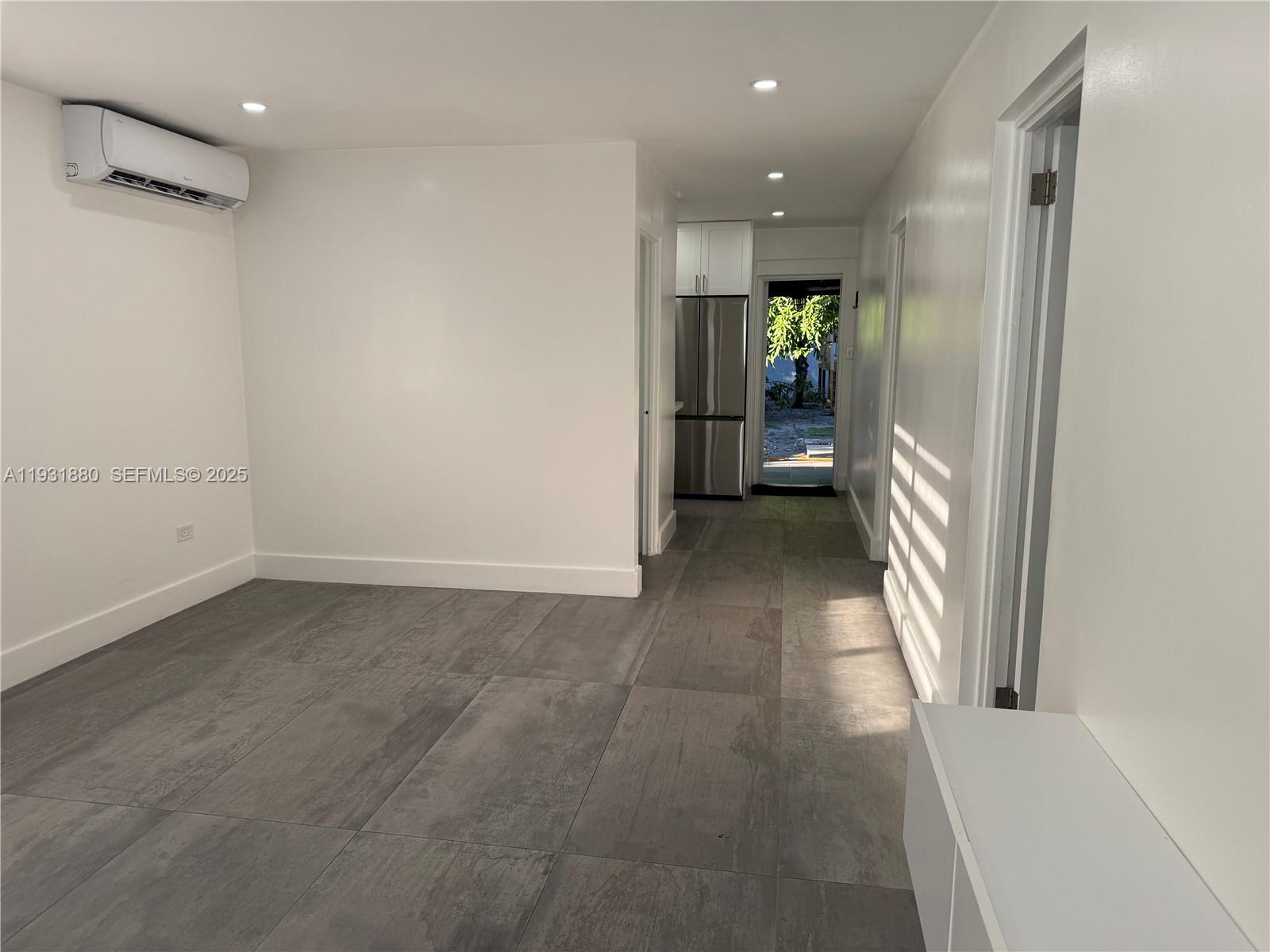 731 East 19th Street Hialeah, FL 33013 - Photo 2 of 17 a view of a hallway with wooden shelves