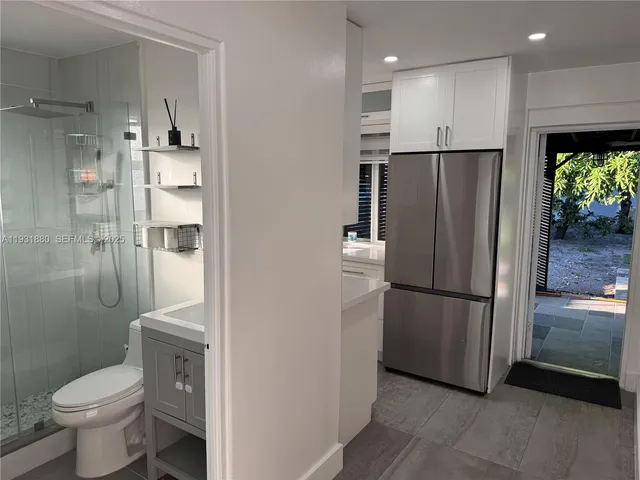 a view of a walk in closet and a bathroom
