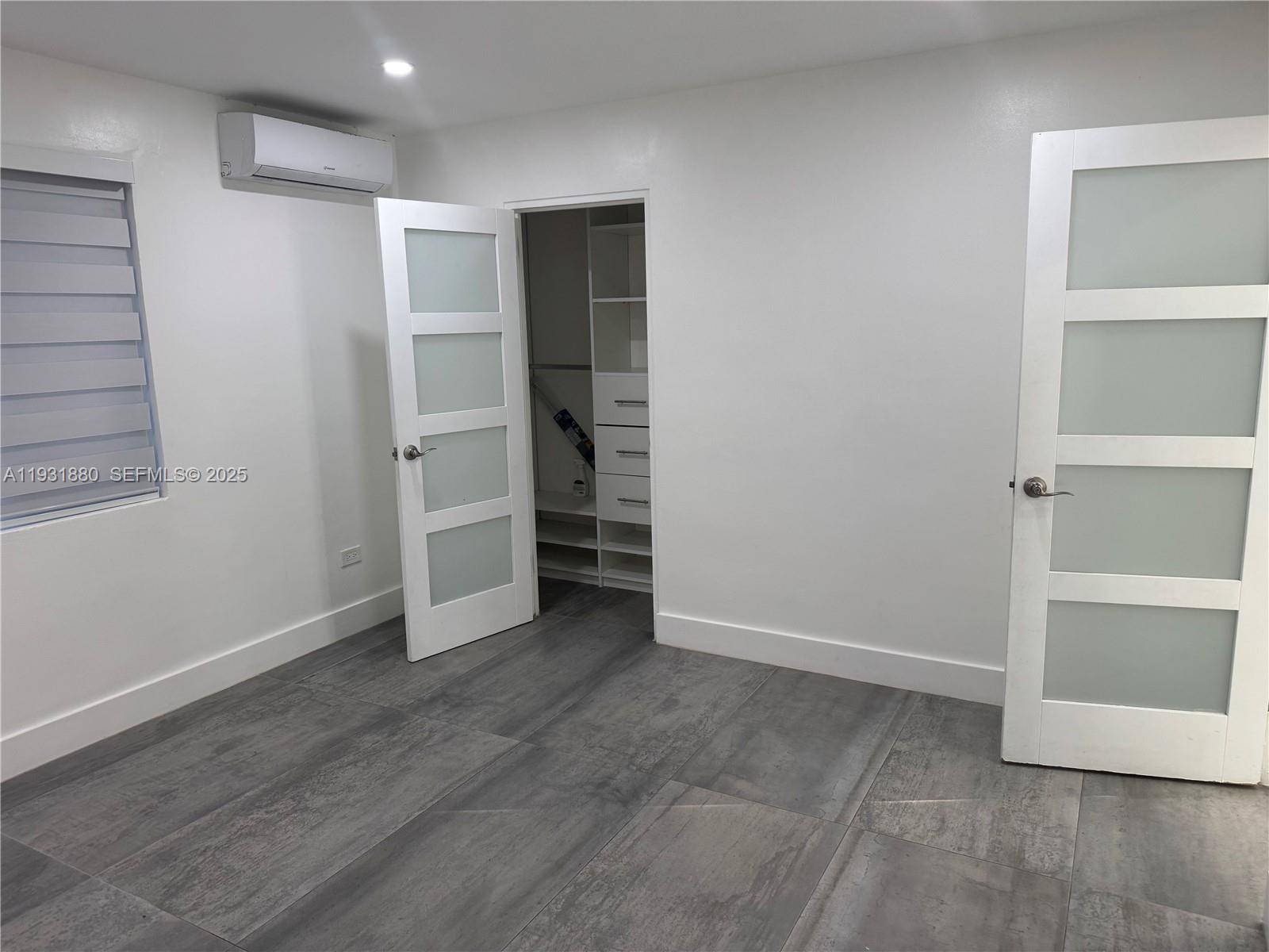 731 East 19th Street Hialeah, FL 33013 - Photo 6 of 17 an empty room with closet and windows