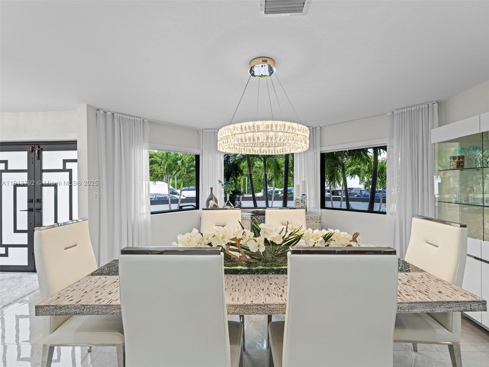 6180 Pine Tree Drive Miami Beach, FL 33140 - Photo 18 of 100 a view of a dining room with furniture window and outside view