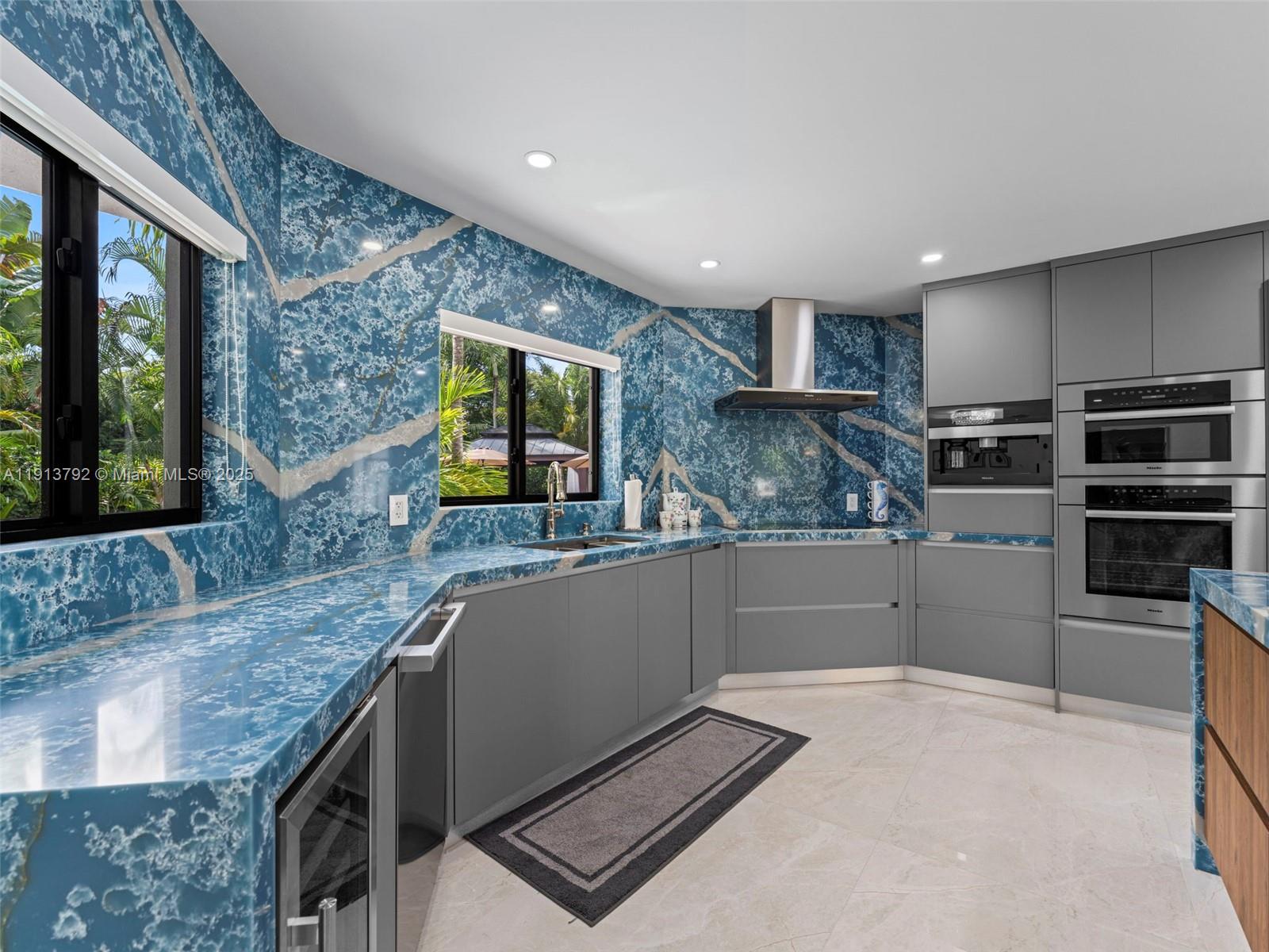 6180 Pine Tree Drive Miami Beach, FL 33140 - Photo 28 of 100 a kitchen with stainless steel appliances granite countertop a sink and a stove