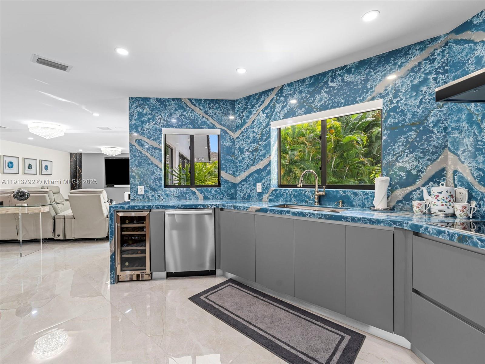 6180 Pine Tree Drive Miami Beach, FL 33140 - Photo 30 of 100 a kitchen with stainless steel appliances a stove and more cabinets