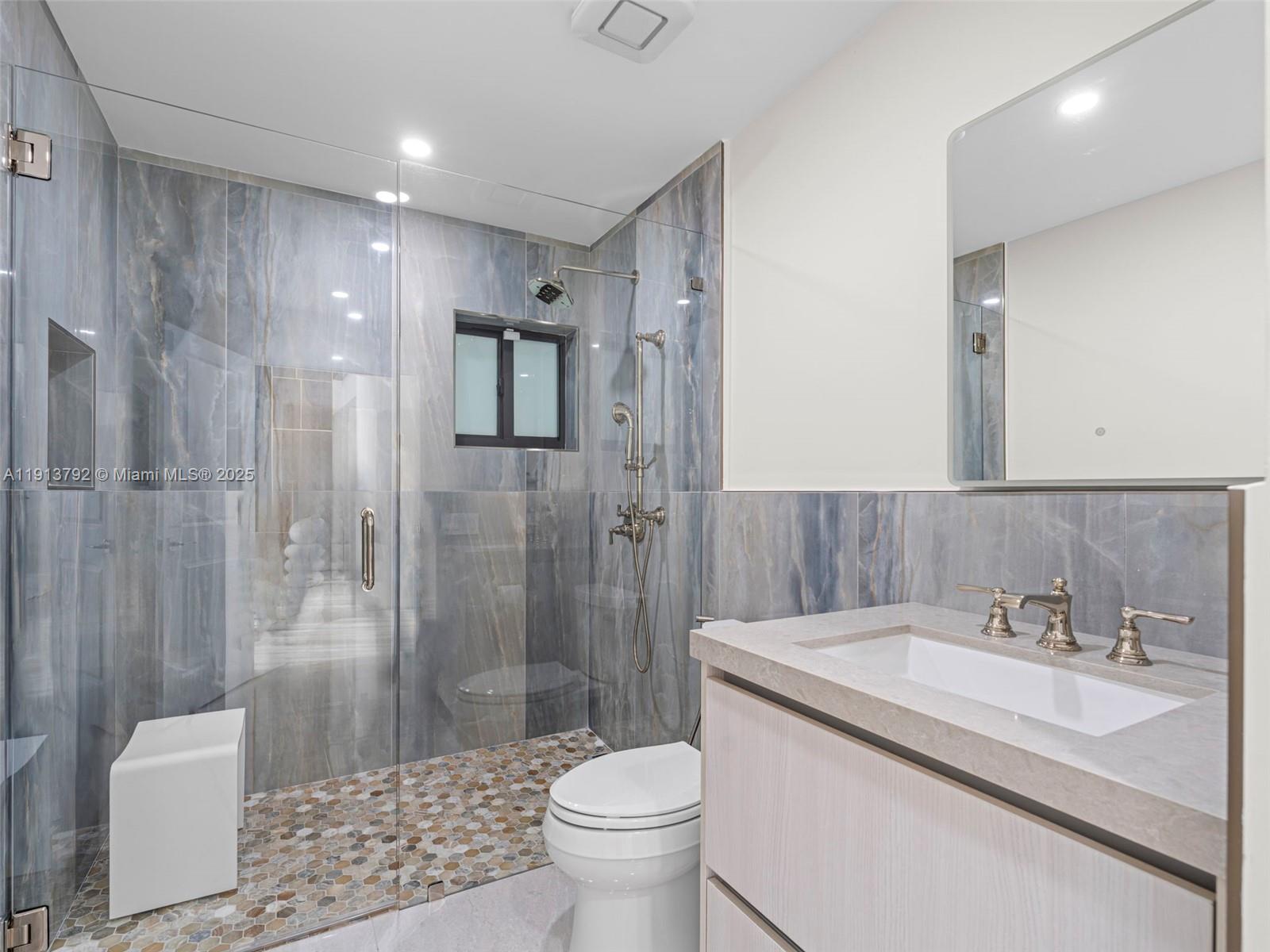 6180 Pine Tree Drive Miami Beach, FL 33140 - Photo 36 of 100 a bathroom with a sink toilet and shower