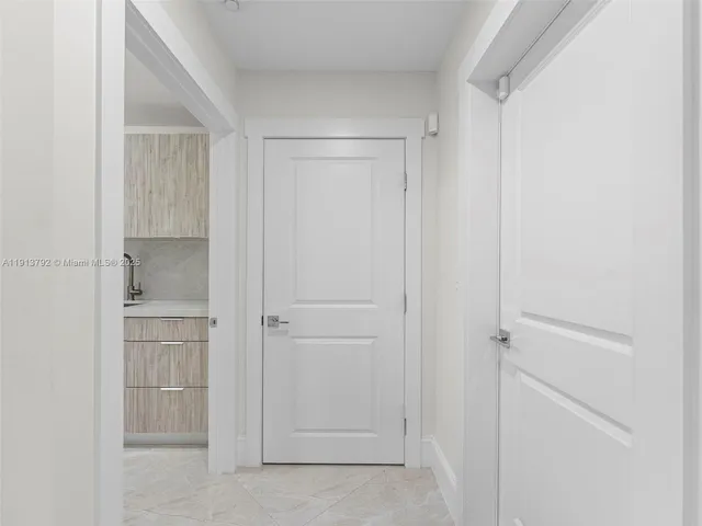 a view of a patio with a table and chairs under an umbrella