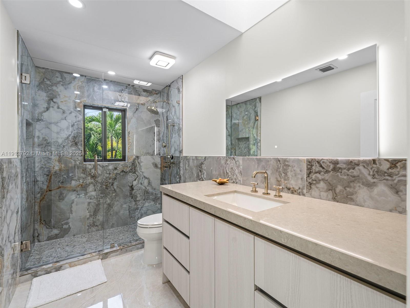 6180 Pine Tree Drive Miami Beach, FL 33140 - Photo 45 of 100 a bathroom with a sink a toilet and shower