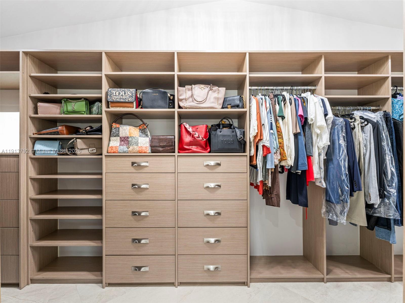 6180 Pine Tree Drive Miami Beach, FL 33140 - Photo 58 of 100 a view of walk in closet with clothes and shoes