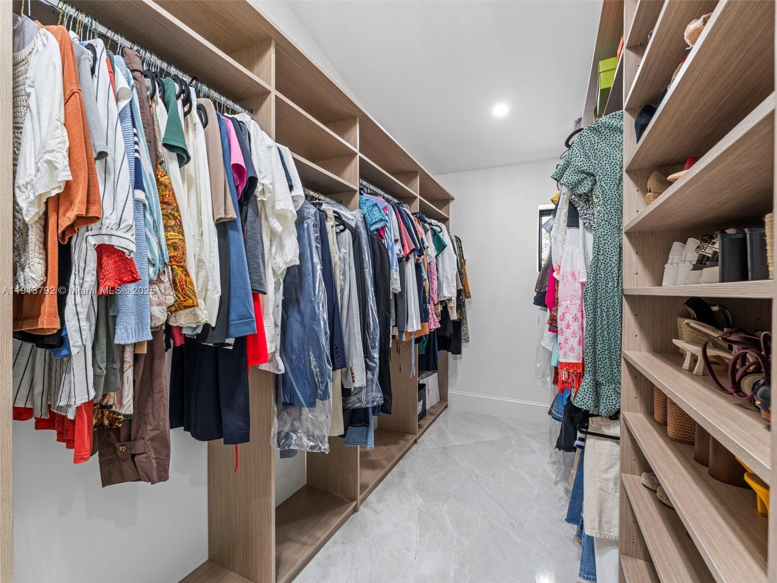 6180 Pine Tree Drive Miami Beach, FL 33140 - Photo 60 of 100 a view of walk in closet with clothes