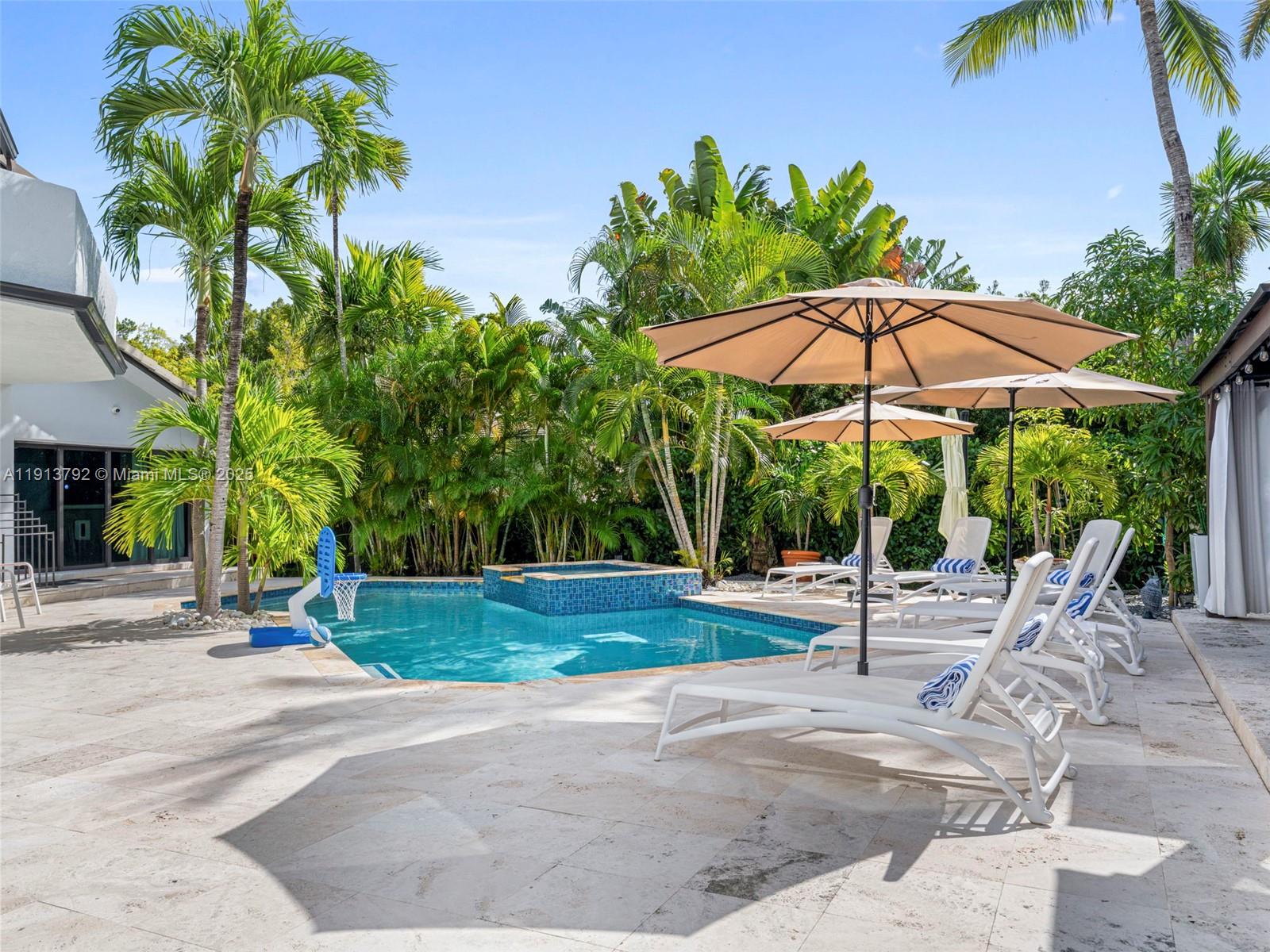 6180 Pine Tree Drive Miami Beach, FL 33140 - Photo 69 of 100 a view of a backyard with a patio