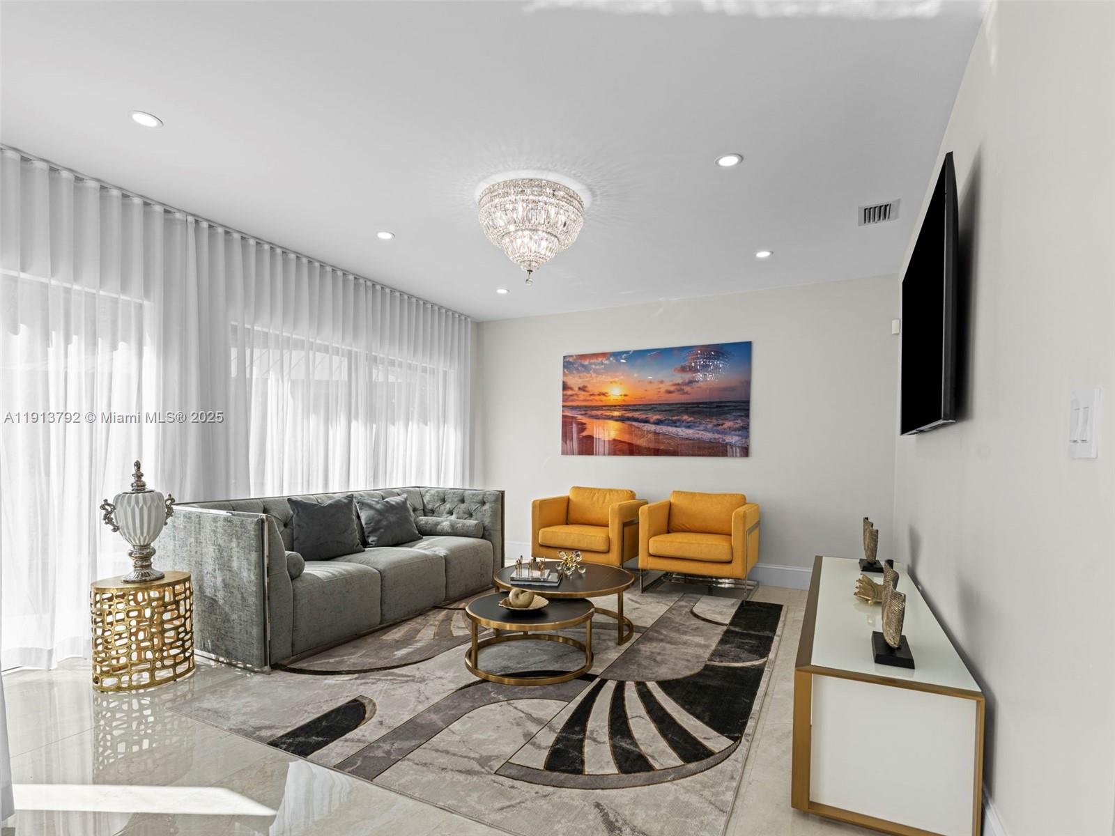 6180 Pine Tree Drive Miami Beach, FL 33140 - Photo 8 of 100 a living room with furniture and a flat screen tv